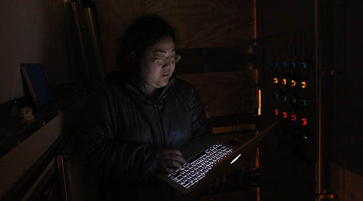 Kaho with some last minute programming. Photo by Ida Benedetto.